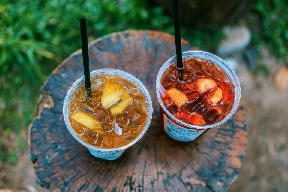 Selective Focus Photo Of Two Juice Filled Plastic Cups