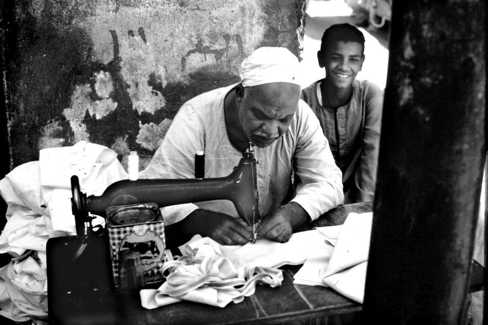 Person Sewing Cloth On Sewing Machine