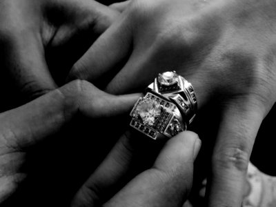 Grayscale Photo Of Person Wearing Two Diamond-encrusted Rings photo