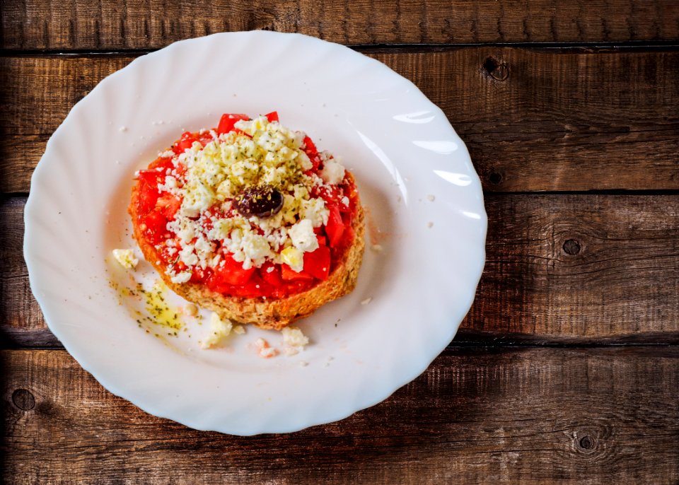 Pastry With Cream In Ceramic Saucer