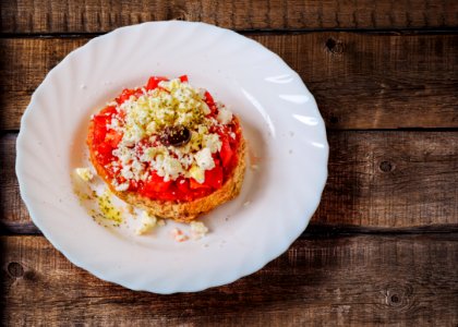 Pastry With Cream In Ceramic Saucer photo