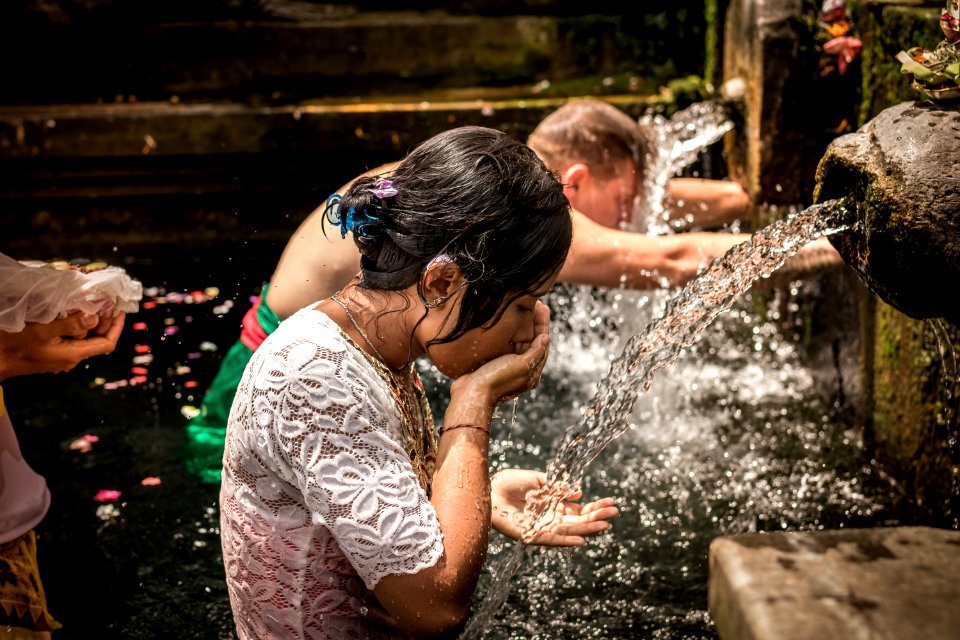 Man And Woman Bathing On Running Water
