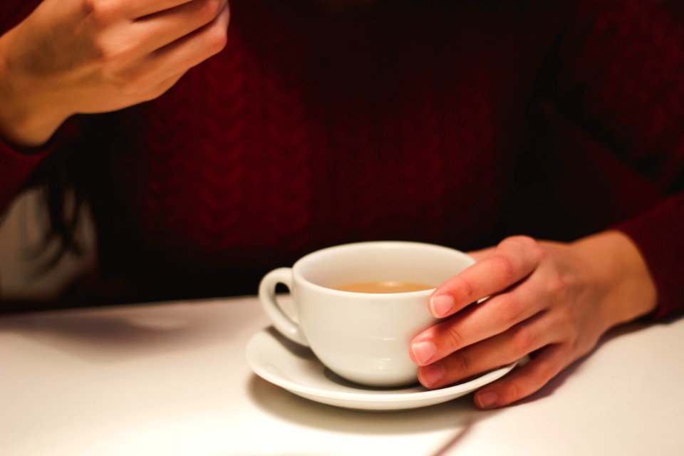 Person Holding White Ceramic Cup photo