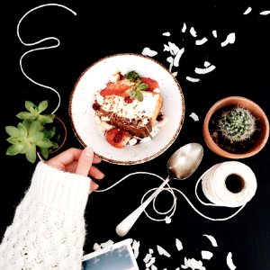 Woman Touching White And Brown Ceramic Saucer With Strawberry Cake