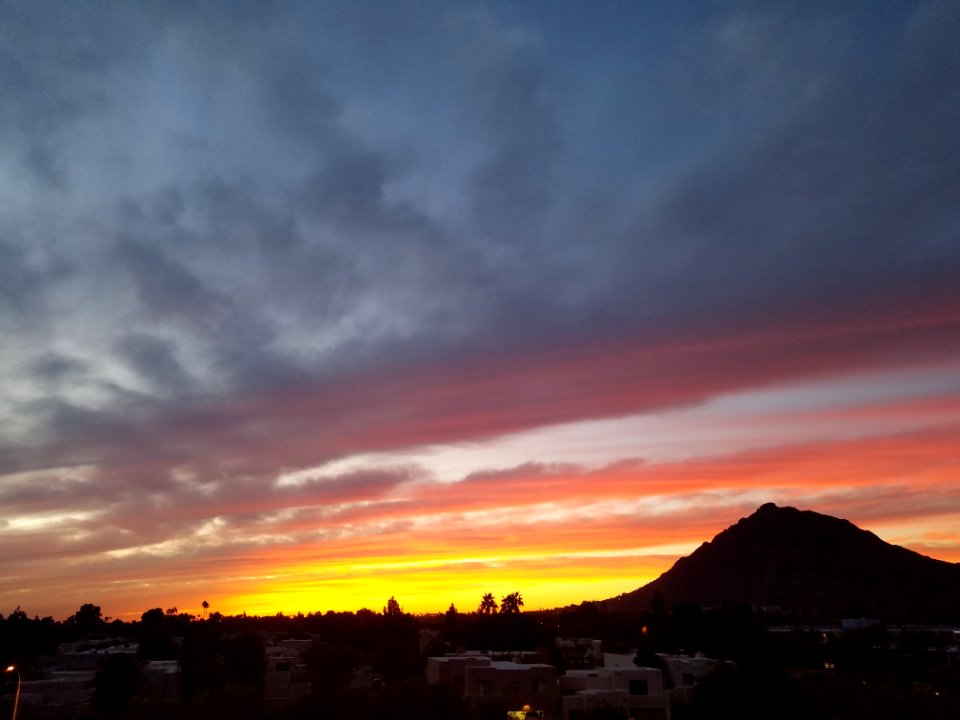 Gray And White Buildings And Brown Mountain During Dusk