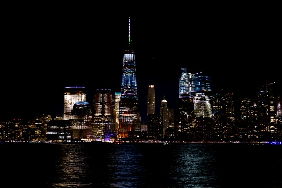 Skyline Beside The Body Of Water At Night Time