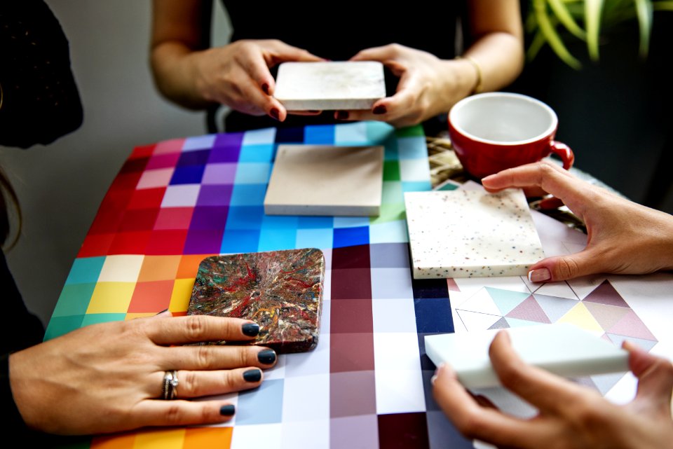Shallow Focus Photography Of Three People Holding Square Panels