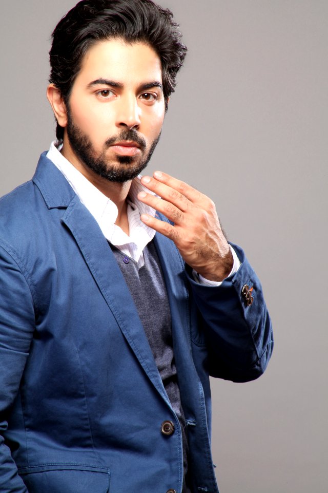 Man About To Touch His Face Wearing Blue Suit