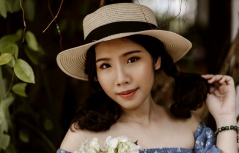 Focus Photography Of Woman In Brown Sunhat Near Vine Plant