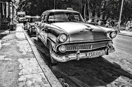 Grayscale Photography Of Vintage Car Beside Pavement photo
