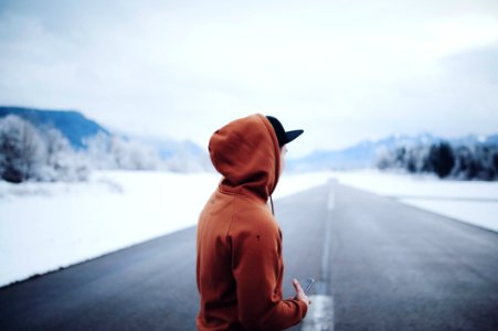 Man Wearing Brown Hoodie In Road photo