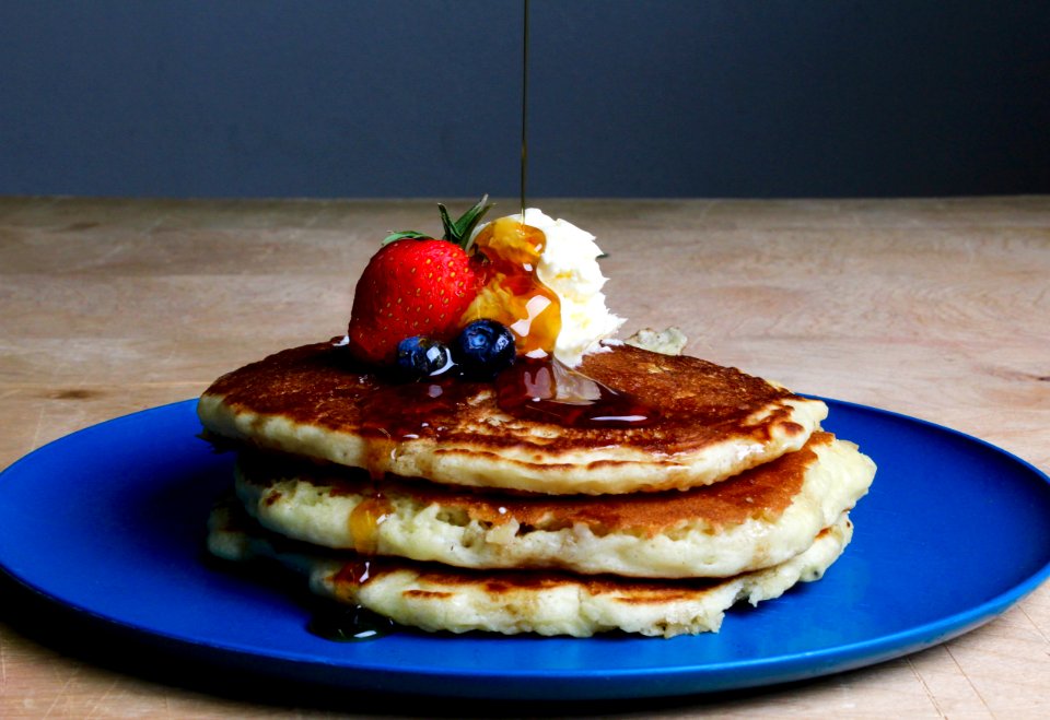 Pancakes With Strawberry Blueberries And Maple Syrup
