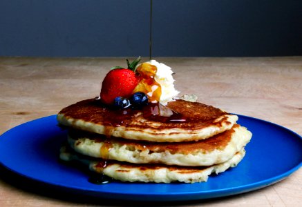 Pancakes With Strawberry Blueberries And Maple Syrup photo