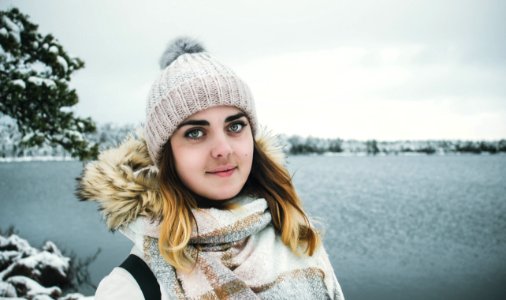 Woman Wearing White Bobble Hat And Jacket