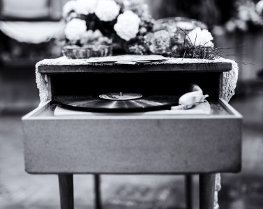 Grayscale Photo Of Vinyl Record Album Playing In Turntable photo