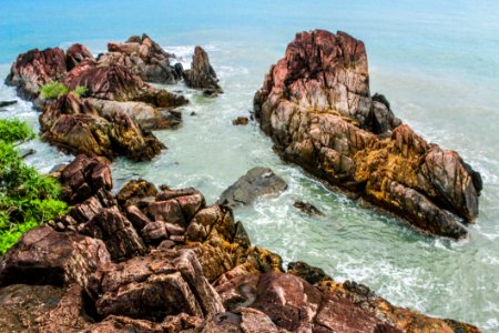 Brown Rock Formations Beside Ocean photo