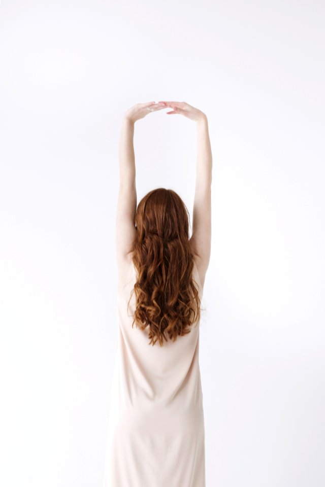 Woman In Beige Dress Stretching Her Hands