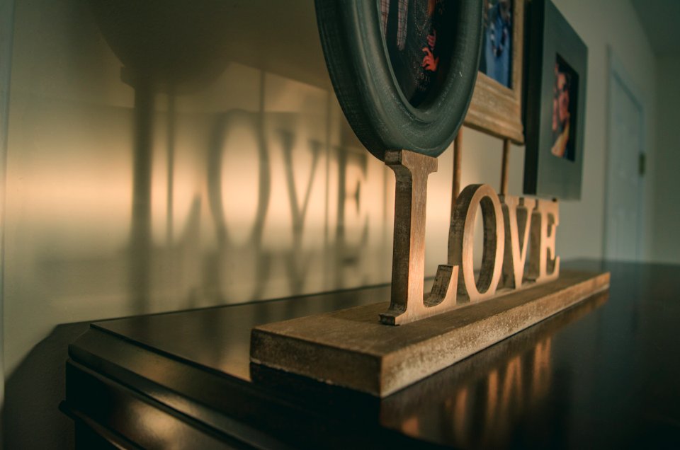 Brown Wooden Love Free Standing Letter On Black Wooden Surface