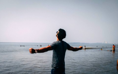Photo Of Man Wearing Gray Shirt Near Sea photo