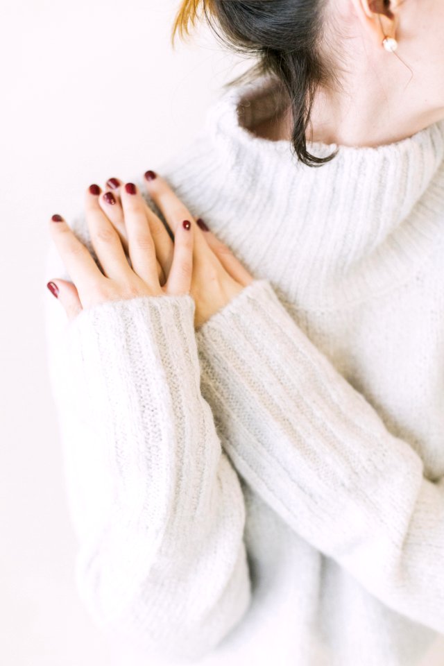 Woman Wearing Turtleneck Sweater In White Surface