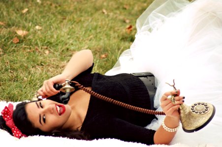 Woman In Black And White Tutu Dress Holding Cradle Phone photo