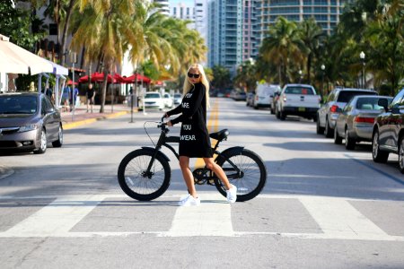 Woman In Black Long Sleeve Shirt Holding Bicycle photo