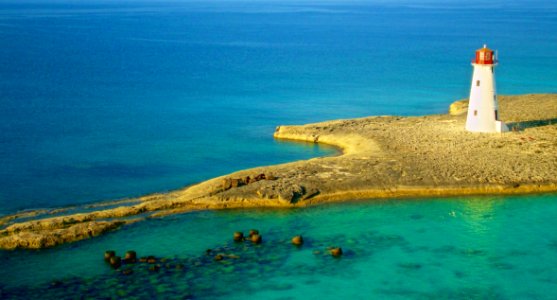 Birds Eye Photography Of White Lighthouse On Island photo