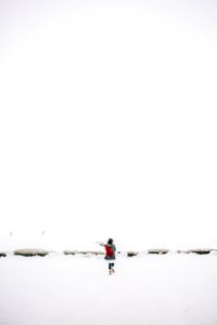 Woman Walking On Snow-covered Field photo