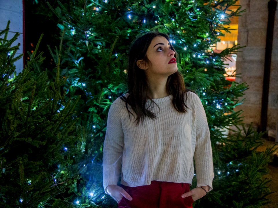 Woman Wearing White Sweater With Red Skirt Near Green Christmas Tree