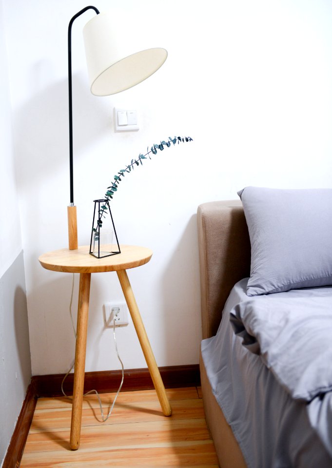 White Shade Table Lamp Near Bed photo