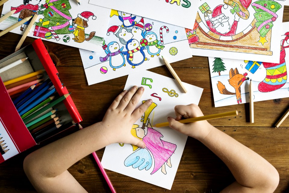 Top Angle Photo Of Child Holding Pencil While Drawing Female Angel Playing Wind Instrument