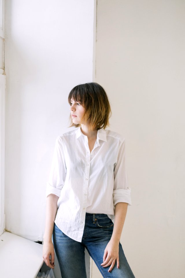 Woman In White Dress Shirt And Blue Jeans photo