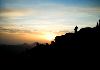 Silhouette Of Group Of Person Hiking On The Mountain