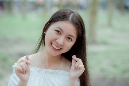 Woman In White Off-shoulder Dress While Taking Selfie photo