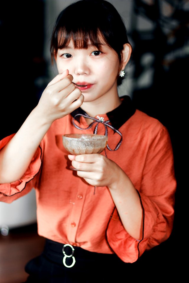 Woman In Orange Dress Holding Brown Liquid Filled Glass Cup