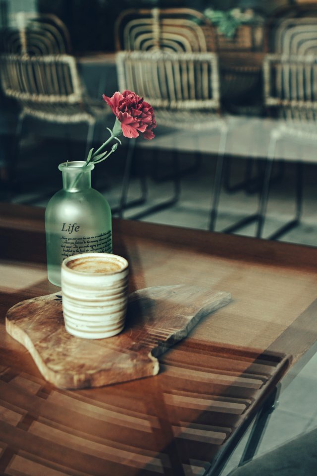 Close-up Photography Of Mug And Flower Vase photo