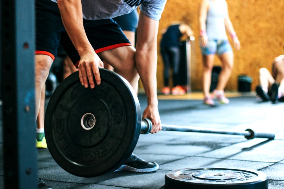 Man Holding Black Barbell