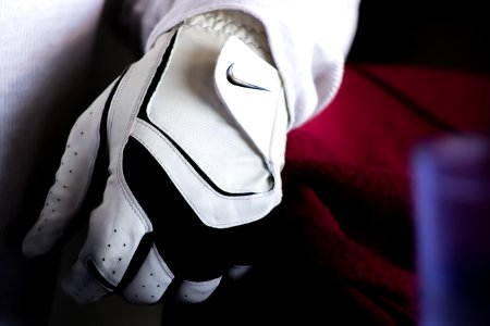 Person Wearing White And Black Nike Leather Glove photo