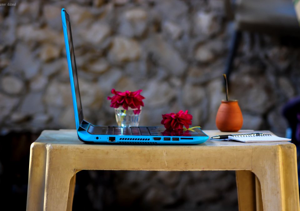 Blue Laptop Computer On Brown Plastic Table