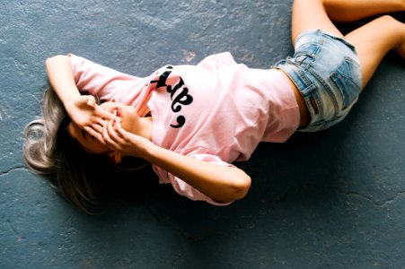 Woman Wearing Pink Printed Crew-neck T-shirt And Blue Faded Denim Shorts photo