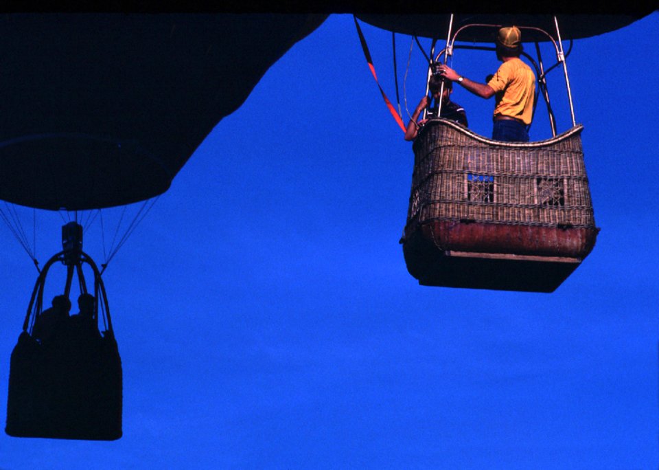 Man Wearing Orange T-shirt Riding On Brown Parachute
