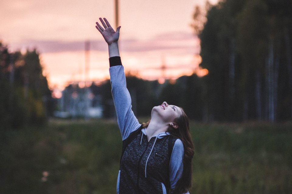 Woman In Gray And Black Zip-up Hoodie Raising Her Right Hand