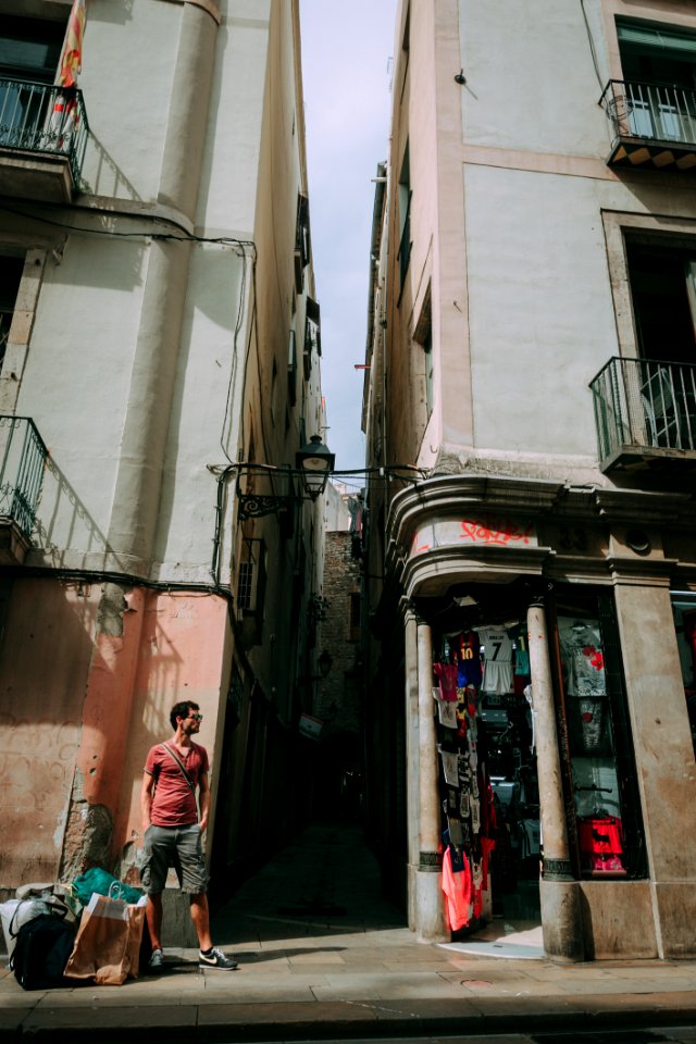 Man Wearing Red Shirt Standing Near A Concrete Structure photo