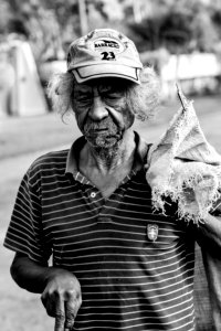 Grayscale Photography Of Man Wearing Polo Shirt And Holding Sack photo