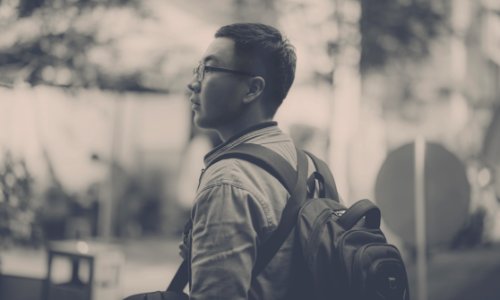 Grayscale Photo Of Man Wearing Backpack photo
