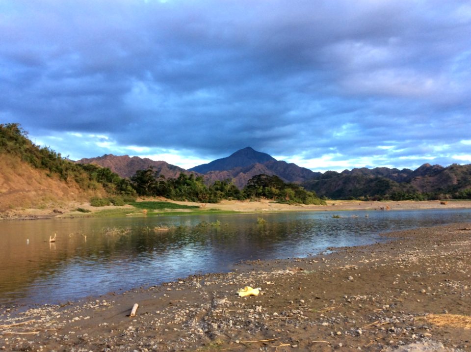 Green And White Mountains Near Body Of Water