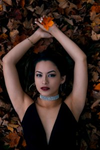 Woman Lying Opening Arms Holding Leaf photo