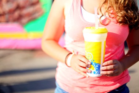 Woman Wearing Pink Tank Top Holding A Tumbler photo