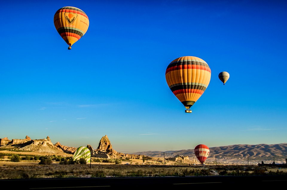 Four Beige Hot Air Balloons Flying