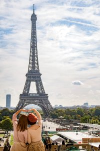Photo Of Two Women Posing In Front Of Eiffel Tower Paris France During Day Time photo